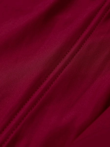 Close-up of wine red mesh dress fabric showing fine texture and durable double-stitch seams