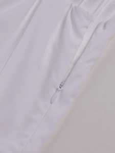 Detailed macro view of high-quality invisible zipper on a white lace dress with smooth fabric