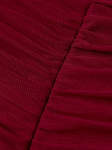 Detail shot of sheer burgundy mesh fabric with elegant vertical pleated textures