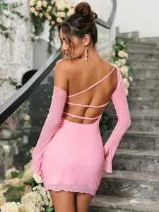 Detailed back view of pink sequin mesh dress with criss-cross straps and open back