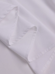 Close-up of white lace dress fabric showing breathable plain weave and fine hem stitching