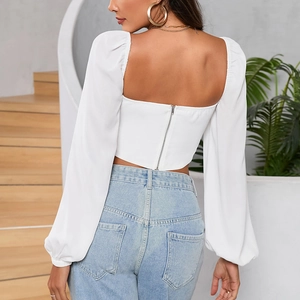 Back view of white square neck cropped top with puff long sleeves and metal zipper