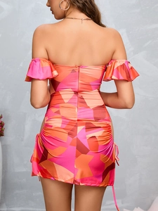 Detail view of the colorful geometric print dress featuring back zipper and side drawstrings