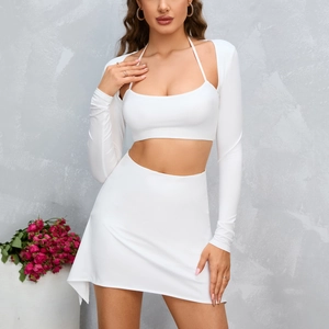 Sexy white two-piece set featuring halter crop top with long sleeves and mini skirt
