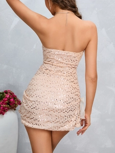 Detail of champagne gold sequin mini dress featuring a mesh bow on the side