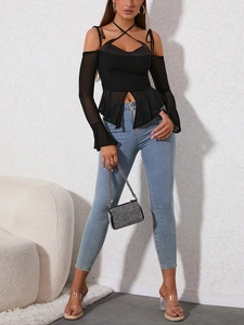 Detail view of black mesh halter top with satin patch and sheer flared sleeves