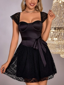 Detail of lace floral pattern on cocktail dress with satin bow tie and elegant corset