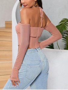 Detail of dusty pink off-shoulder mesh sleeve top with halter tie and corset hem