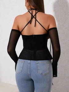 Detail view of the back zipper and sheer mesh long sleeves on this sexy halter neck top