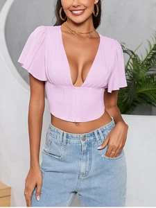 Detail of light purple corset top with ruffled sleeves and pleated v-neckline