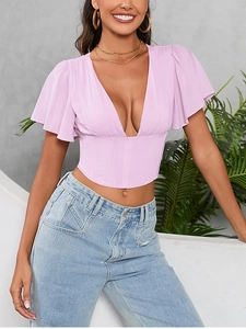 Detail of pink corset-style chiffon top featuring ruffles and structured boning
