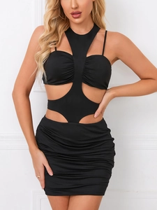 Detail of black halter dress featuring geometric cutouts and elegant pleated textures