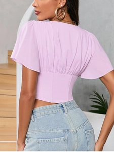 Detail of lavender chiffon top showing back pleats and ruffled hem design