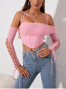 Detail of pink mesh corset top with boning structure and lace-up cutout long sleeves