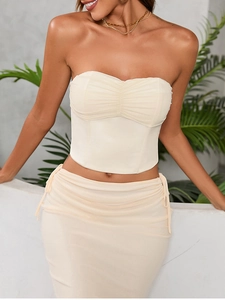 Detail of light beige mesh strapless corset top featuring delicate front ruching and slim fit