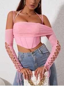 Detail of pink corset top with sheer mesh sleeves and criss-cross hollow out design