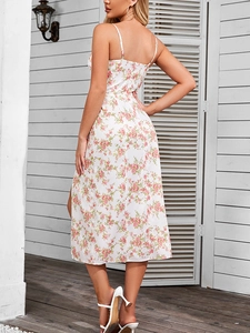 Detail of floral halter dress with side slit and delicate pink floral patterns on white fabric