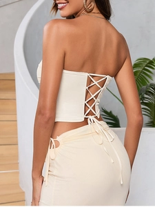 Detailed back view of a cream lace-up bustier corset top with elegant cross-tie straps