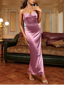Close-up of pink satin dress featuring delicate lace trim and adjustable bow detail