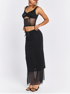 Détails de la jupe patchwork noire avec textures en dentelle et nœud élégant à la taille
