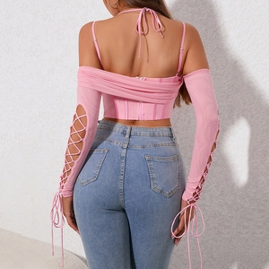 Pink off-shoulder corset top with lace-up sleeves and back zipper, styled with light denim