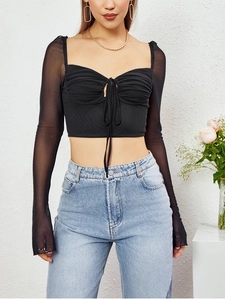 Detail of the black mesh long sleeve crop top with drawstring ruched front and sheer sleeves