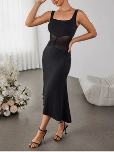 Detail of the mesh splicing and pleated waist texture on a black bodycon midi dress