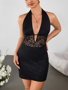 Detailed texture of black floral lace fabric on a sexy deep V-neck halter mini dress