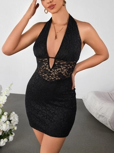 Close-up detail of sheer floral lace patchwork and hollow out design on black mini dress