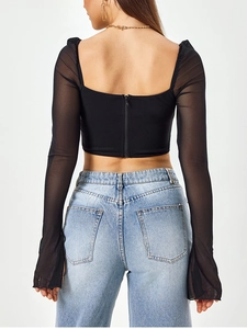 Close-up of the back zipper detail and mesh bell sleeves on this black slim fit crop top