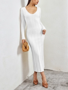 Detail of white ribbed knit fabric on a slim-fit long-sleeve dress with a deep U-neckline
