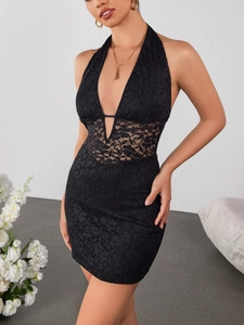 Detailed close-up of intricate black floral lace patchwork on a mini bodycon dress