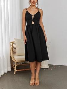 Detail of elegant black hollowed-out U-neck dress with thin straps and a pleated A-line skirt