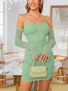 Detail of light green ruched mesh mini dress with bone support and flared long sleeves