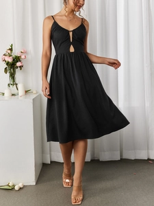 Detail of a black midi dress featuring hollow-out chest design and flared A-line skirt