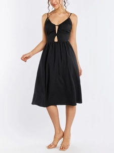 Detail of a black midi dress featuring thin straps and a stylish cutout neckline detail