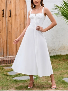 Close-up of white midi sundress featuring ruched bodice and delicate tie straps detailing