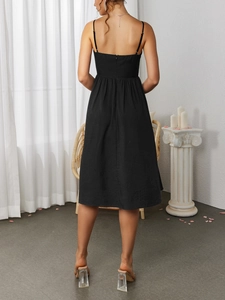 Back view of black A-line midi dress featuring thin straps and back zipper detail