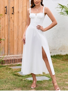 Detail of white midi dress showing high side slit and elegant lace-up bodice design