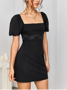 Detailed close-up of square neck dress with lantern sleeves and floral lace waist panel