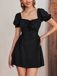 Detailed view of the lace-up corset waist and puff sleeves on a black mini dress