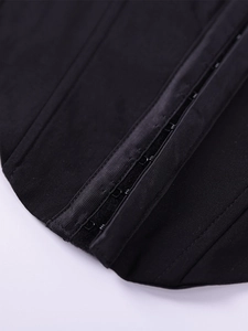 Macro detail of multi-row hook-and-eye closure on black mesh corset crop top