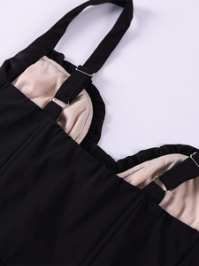 Close-up of adjustable spaghetti straps and ruffled lace edges on a black corset top