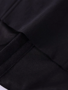 Close-up detail of high-density mesh fabric and neat flat-seam stitching on black corset top