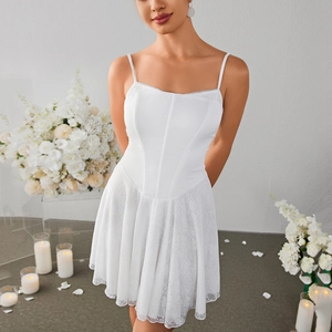 White corset mini dress with lace A-line skirt and thin straps in floral setting