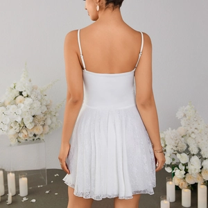 White mini dress featuring delicate lace hem and adjustable straps with a back view