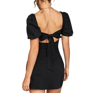 Elegant backless black dress with puff sleeves and a large bow tie on the back