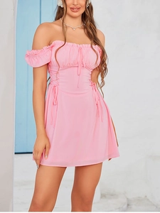 Detailed view of pink puff sleeve mini dress featuring ruffled neck and lace-up bodice design