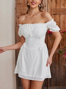 Detail of white puff sleeve mini dress with lace-up waist and ruffled neckline