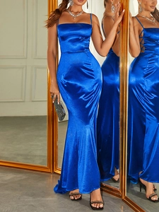Detail of satin evening gown showing the slim straps and cross-lace design on the side